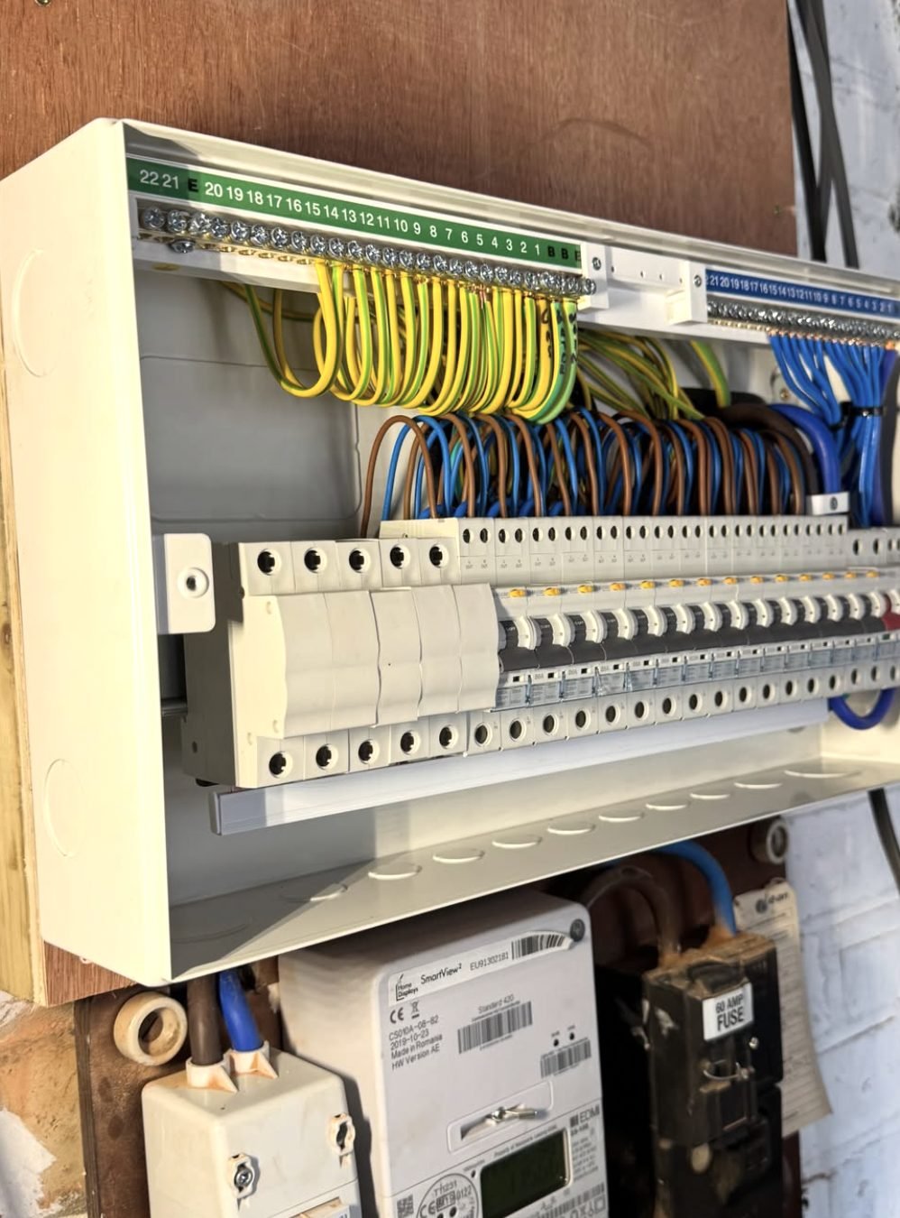 Older consumer unit and meter being worked on during an emergency call-out