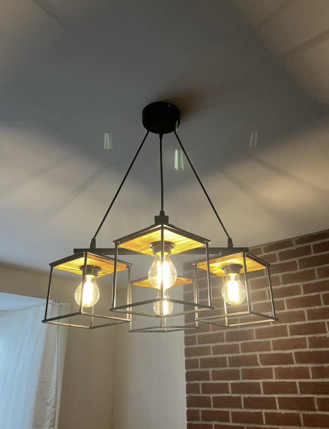 Four lamp cage pendant light fitted to a ceiling