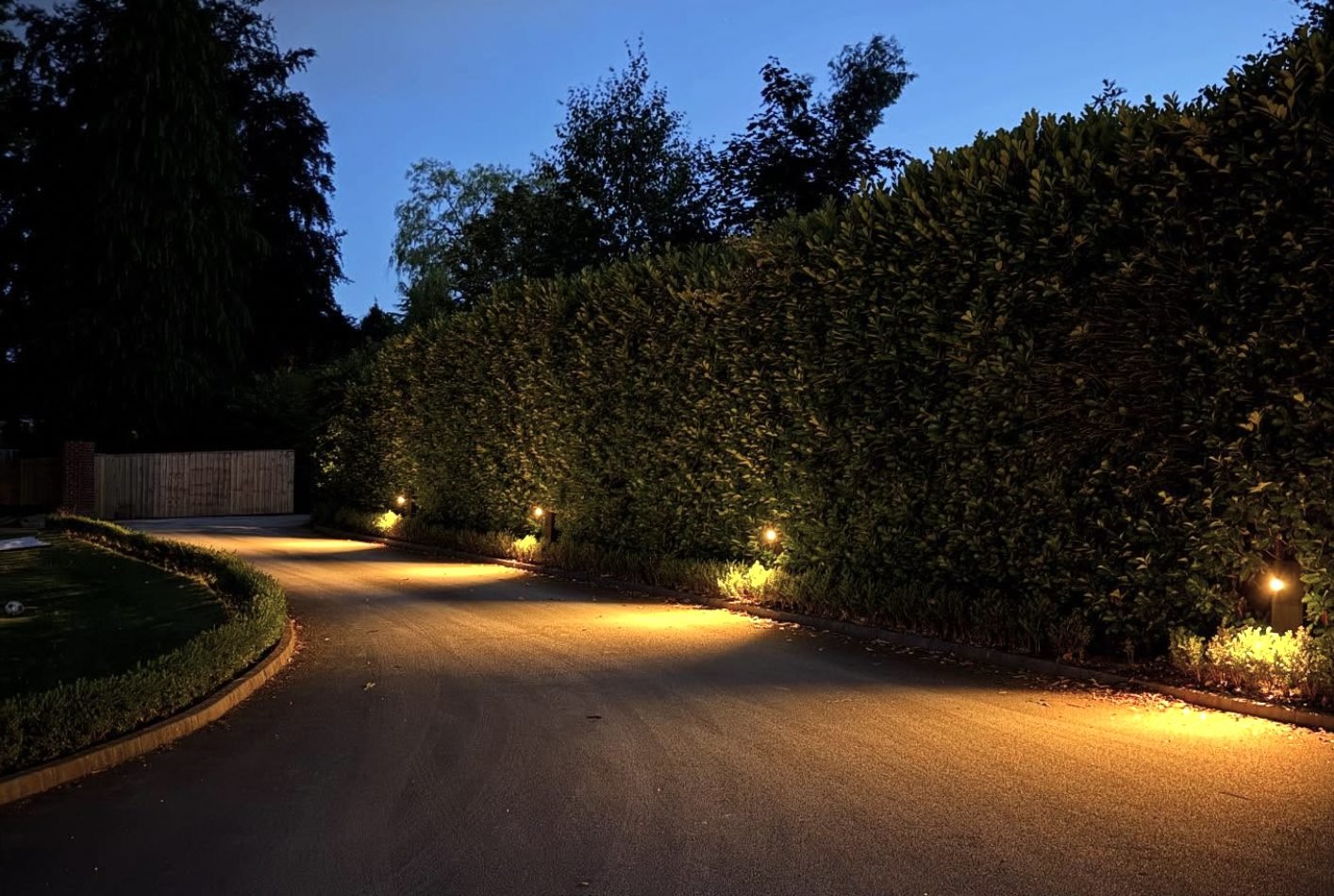 Driveway and pathway lighting installed by Electrician To The Rescue, lit at dusk