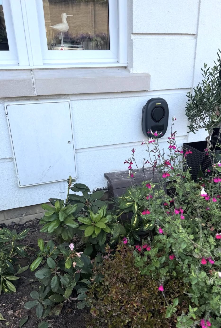 EV charge point installed on a rendered front elevation