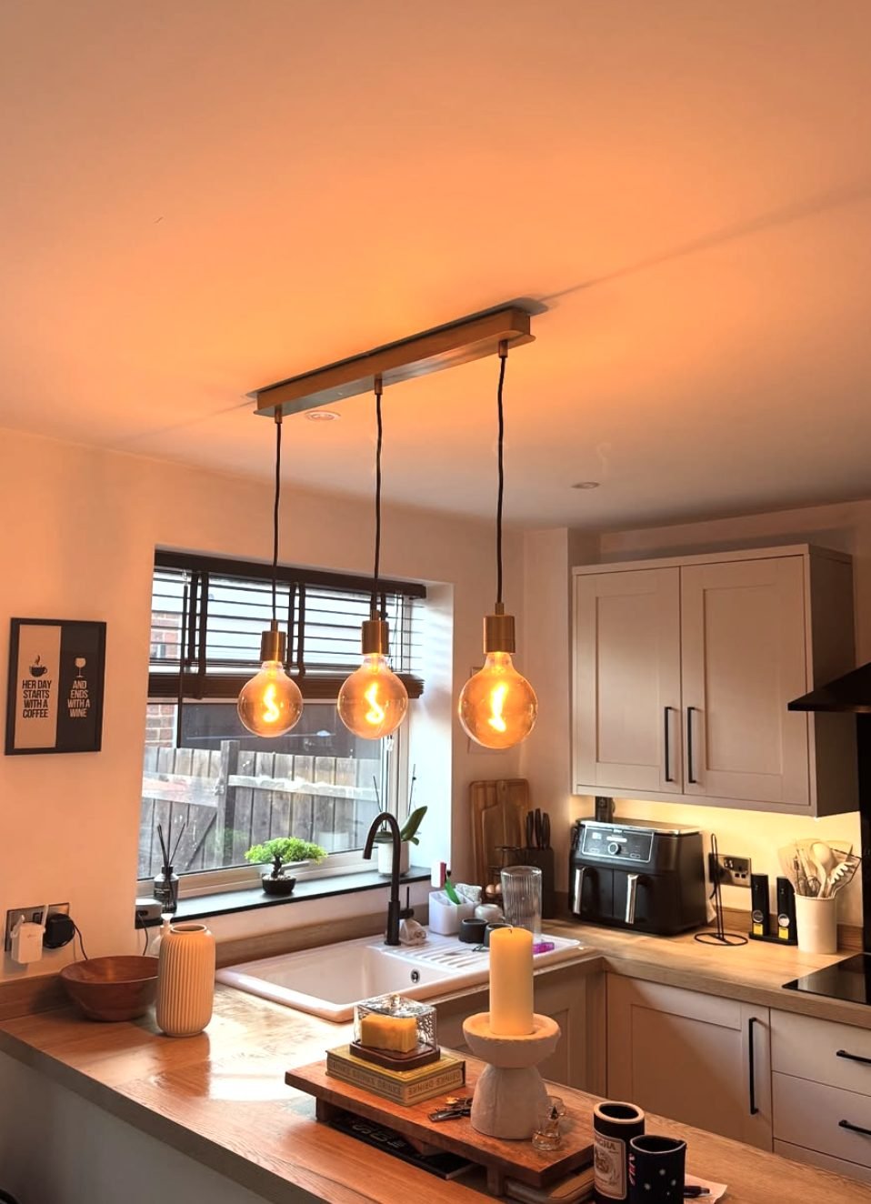 Three pendant lights fitted over a kitchen worktop