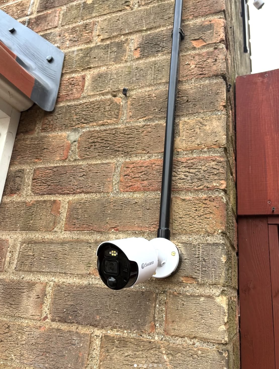 External security camera fitted to a brick wall